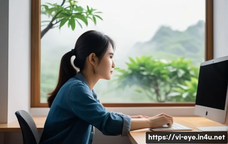 안구건조증 완화 습관 - A Vietnamese office worker in their late 20s sitting at a modern desk with a computer screen at eye ...